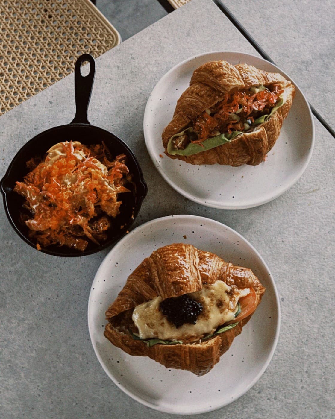 Savoury stuffed croissants with smoked salmon and caviar on plates at Croissand Cafe, City Gate