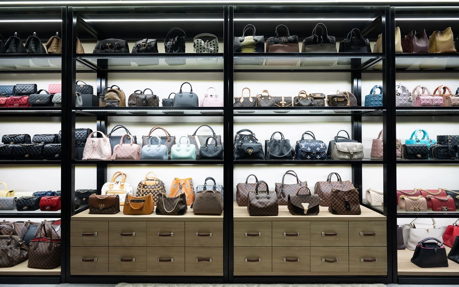 Shelves of authenticated pre-owned designer handbags, at Neverfull Luxury