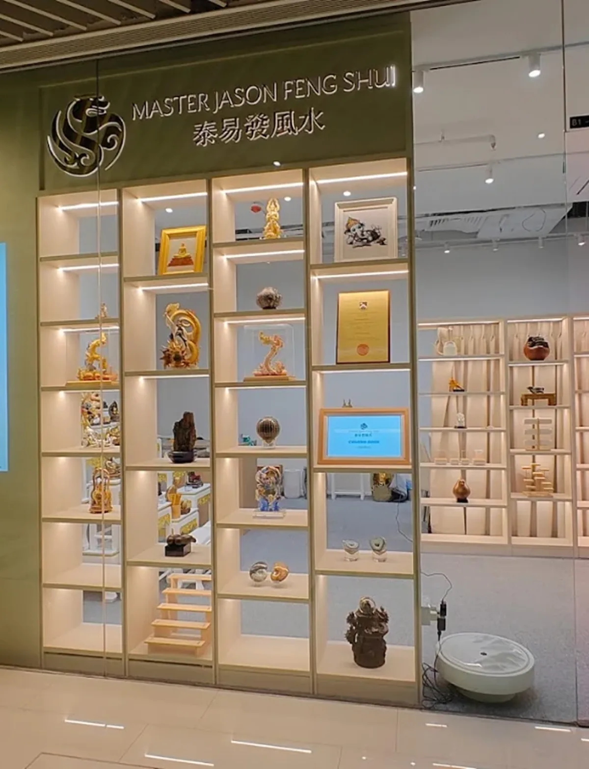 The Master Jason Feng Shui storefront at City Gate, its lit display shelves of feng shui pieces behind the glass