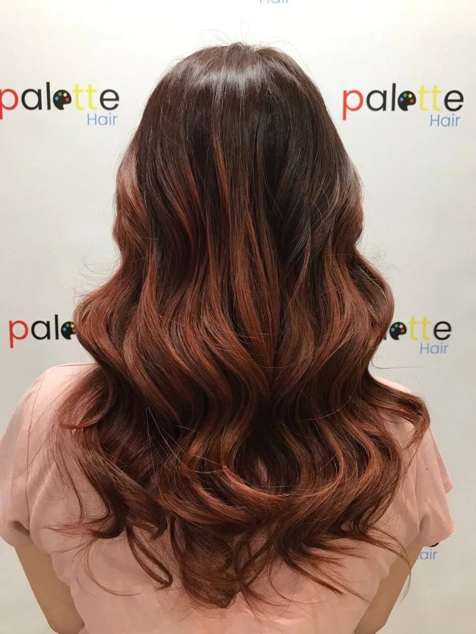 A colour-and-curl result on the Palette Hair branded backdrop, City Gate