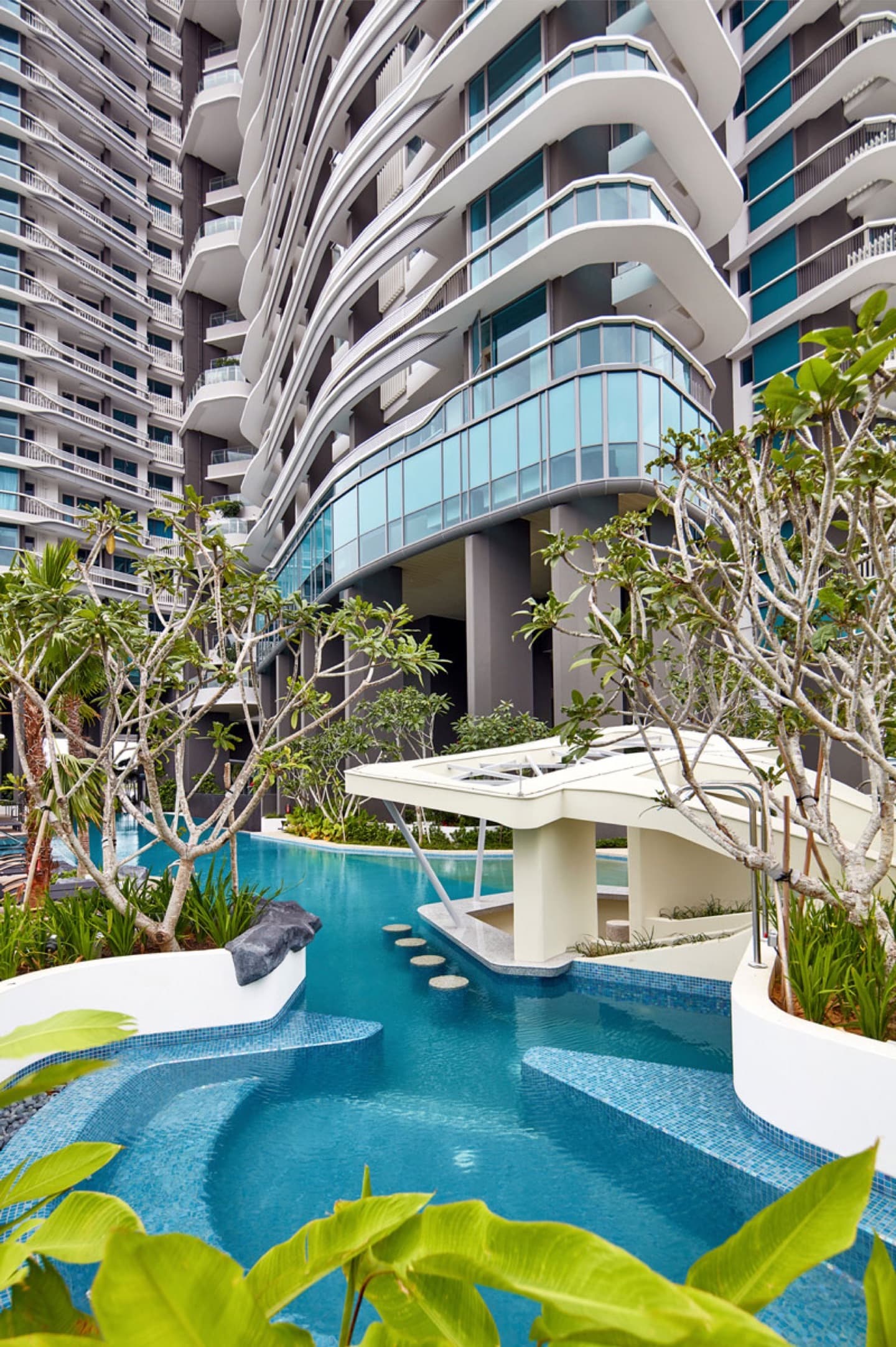 City Gate Residences — the pool deck beneath the curved residential balconies