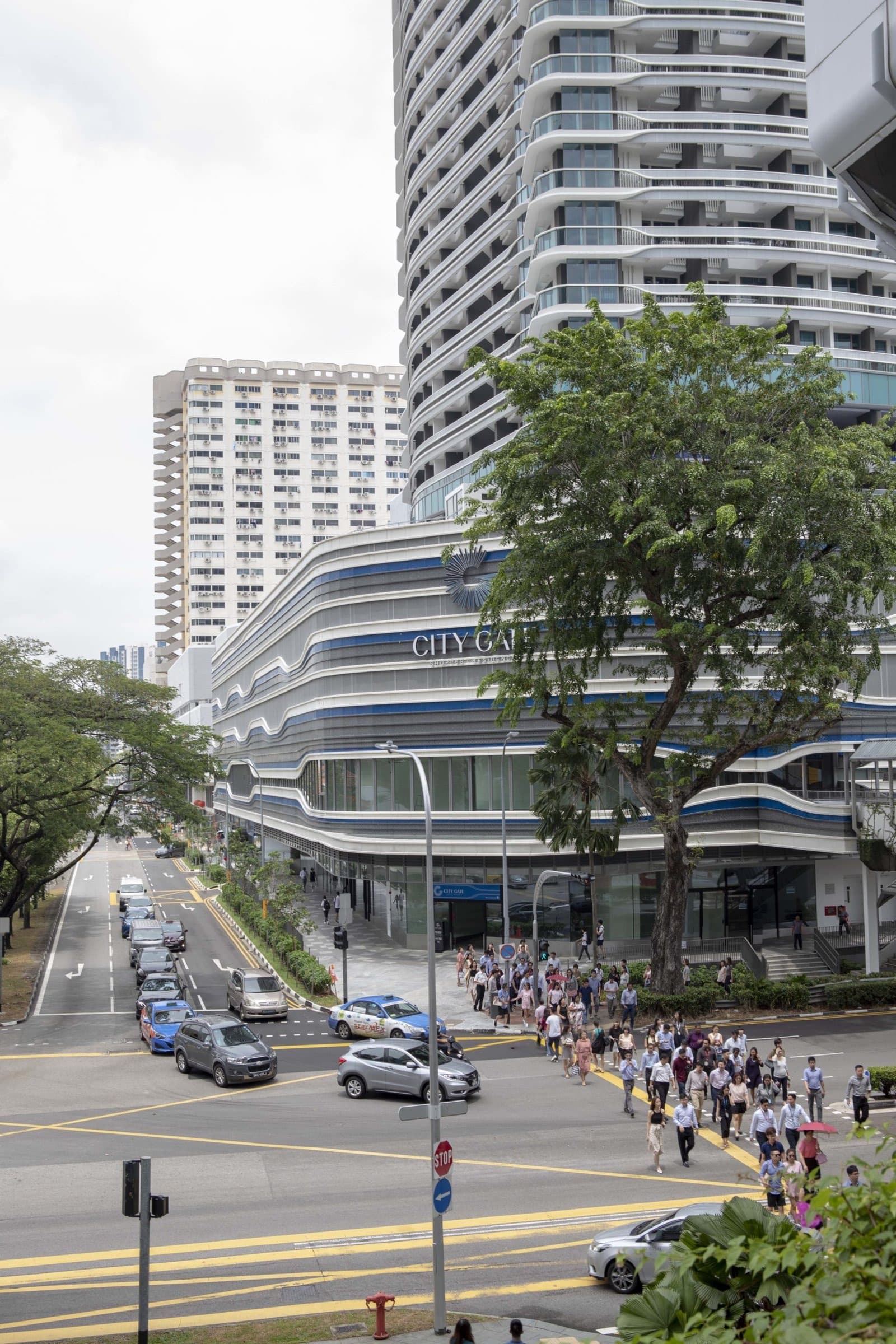 Shoprs crossing at the junction outside City Gate on Beach Road